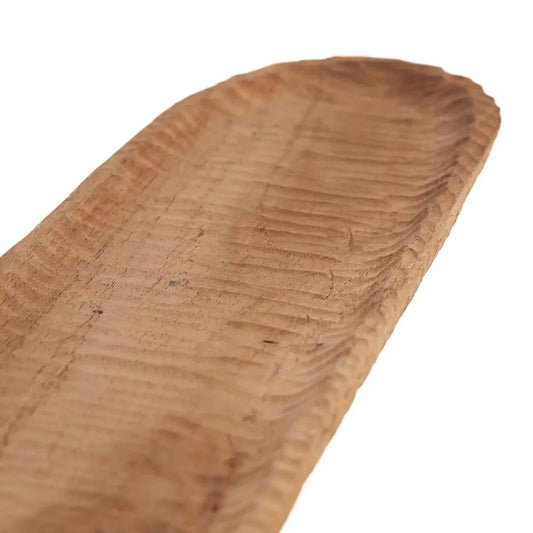 Slender teak wood bread server with hand-carved textures.