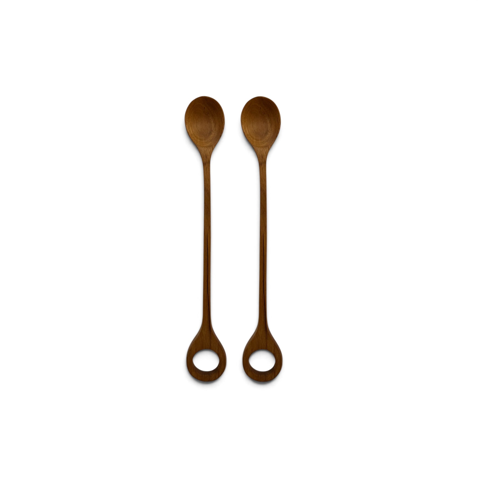 Pair of long hand-carved teak wood spoons with circular ring handles side-by-side on a white background.