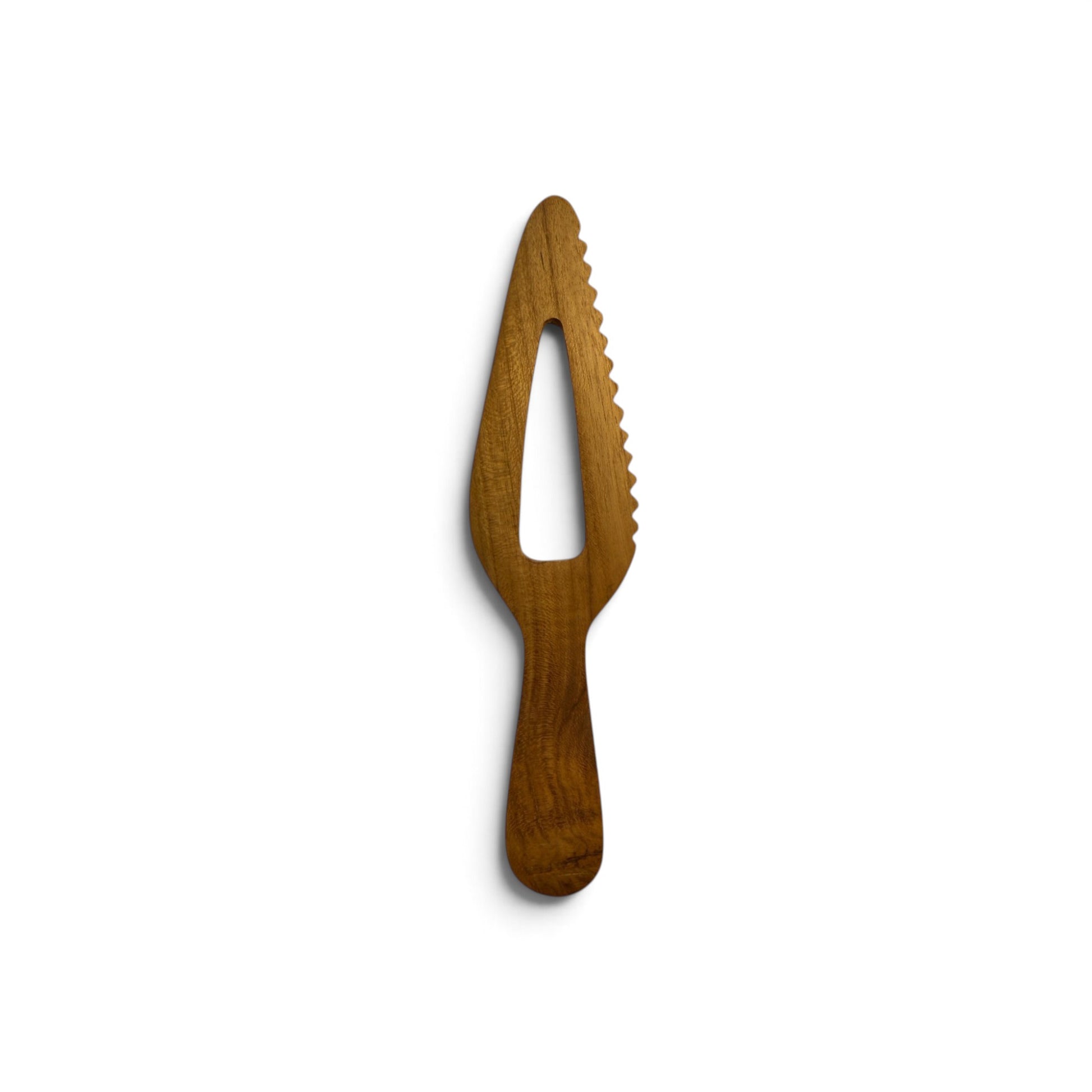 Top-down view of hand-carved serrated teak wood server displaying natural timber grain.