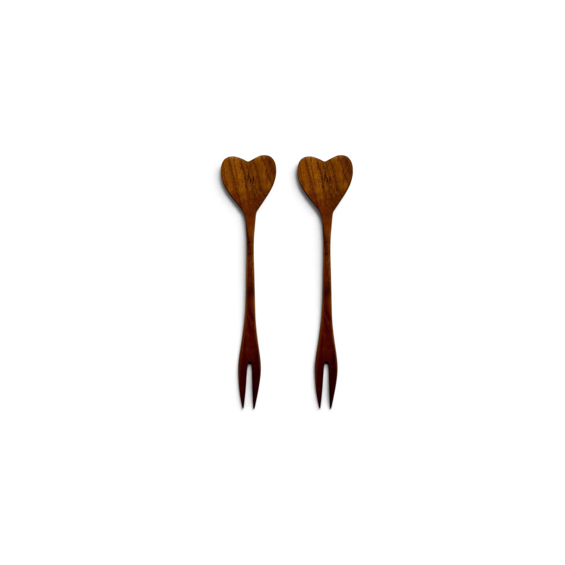 Pair of hand-carved heart-shaped teak wood cocktail forks side-by-side on a white background.