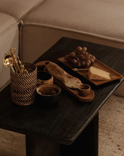 Slender teak wood bread server with hand-carved textures.