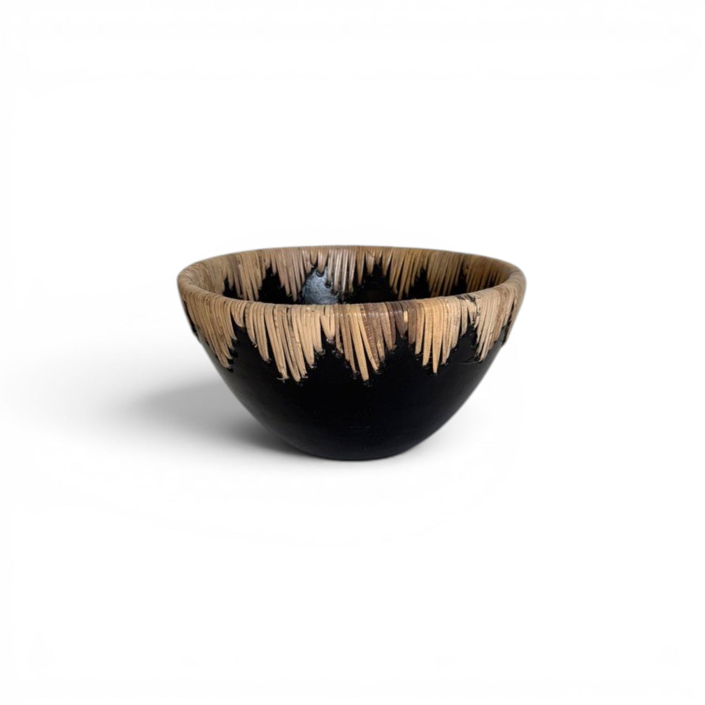 Large circular matte black terracotta decorative centerpiece bowl with a continuous crown border of stitched natural rattan fringe running along the inner and outer rim -Malta