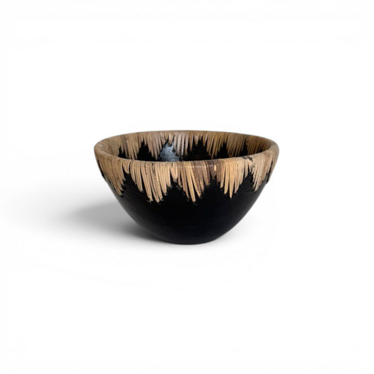 Large circular matte black terracotta decorative centerpiece bowl with a continuous crown border of stitched natural rattan fringe running along the inner and outer rim -Malta