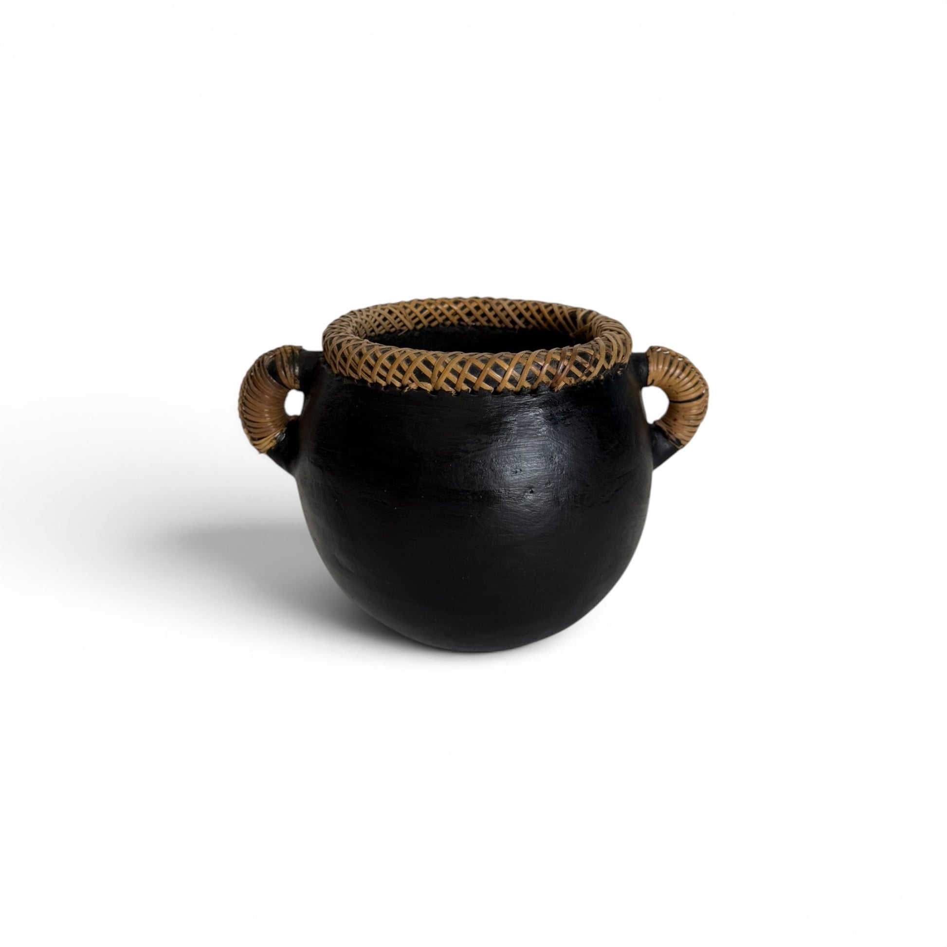 Compact round matte black terracotta decorative pot featuring a hand-woven cross-hatched natural rattan rim collar and two matching coiled loop side handles.