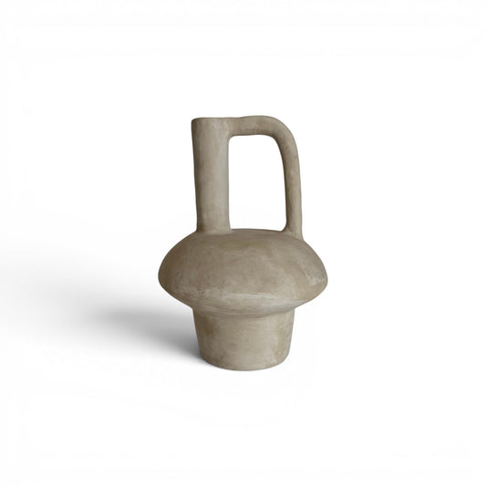 Sculptural sandy beige terracotta vase with a tiered mid-section, an off-center narrow neck spout, and an integrated geometric loop handle