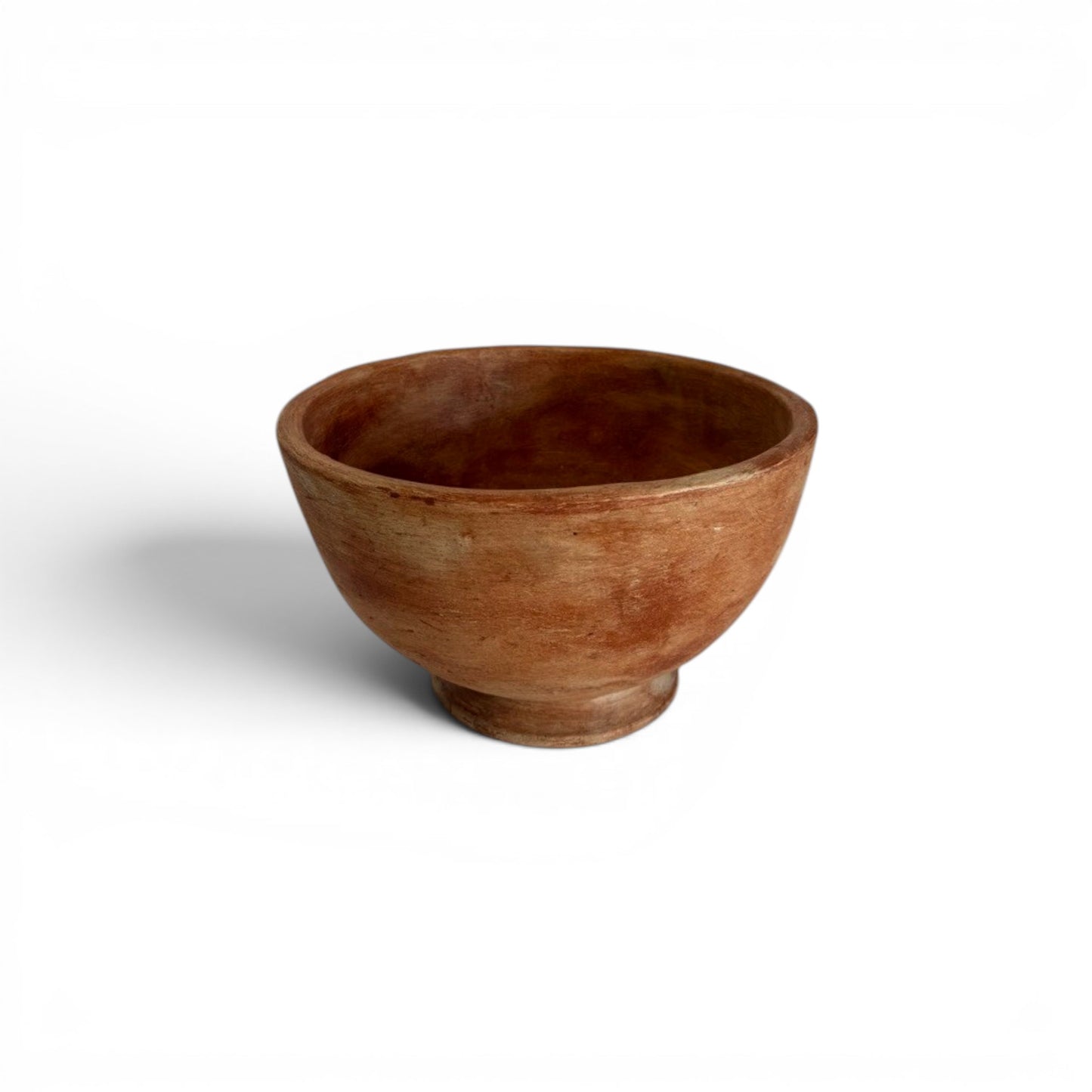 Large, wide-rimmed warm orange terracotta decorative bowl resting on a short, flared pedestal foot base with a weathered, textured finish.