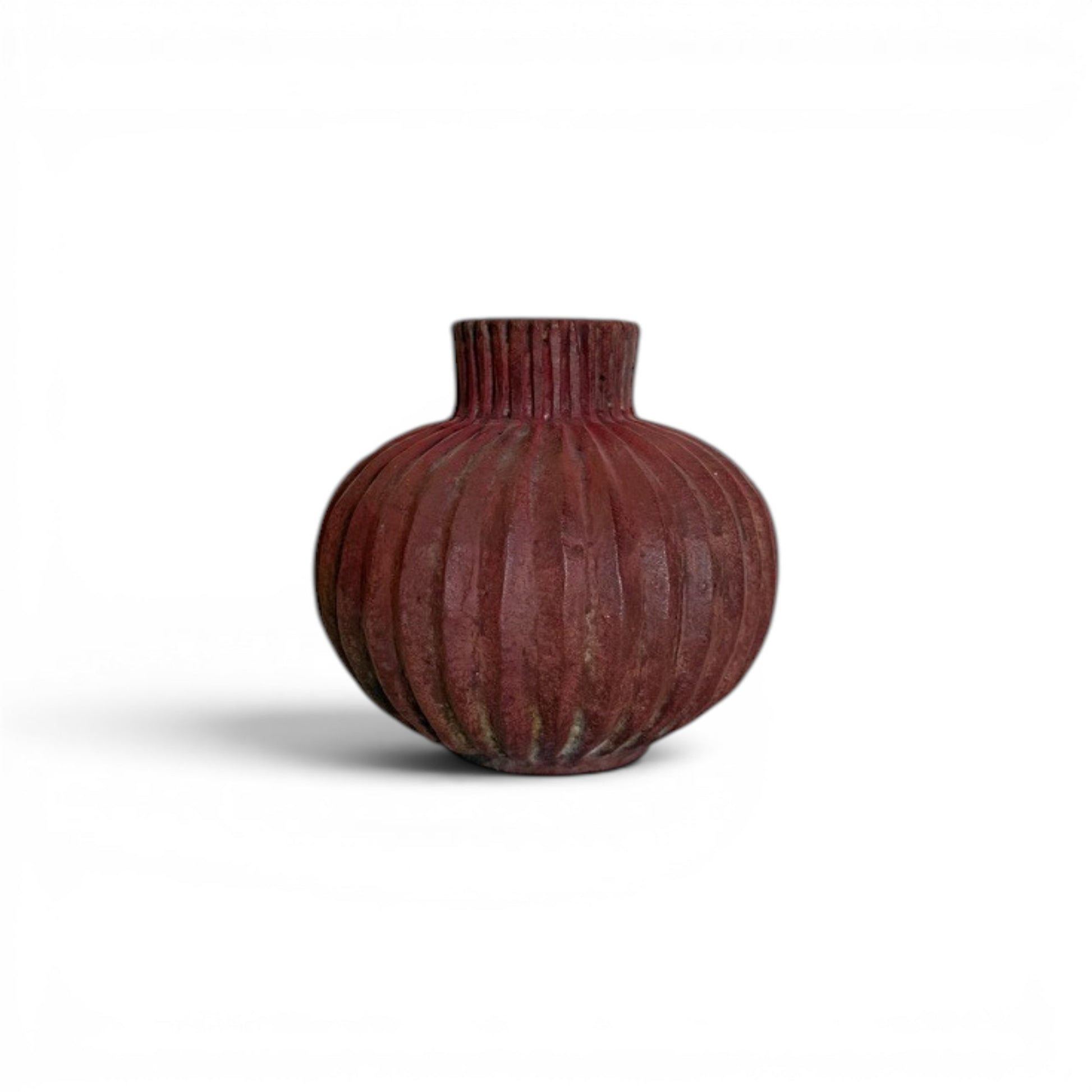 Compact, round earthy red terracotta vase with dense vertical fluted ridges running from the base up through the short neck to the rim.