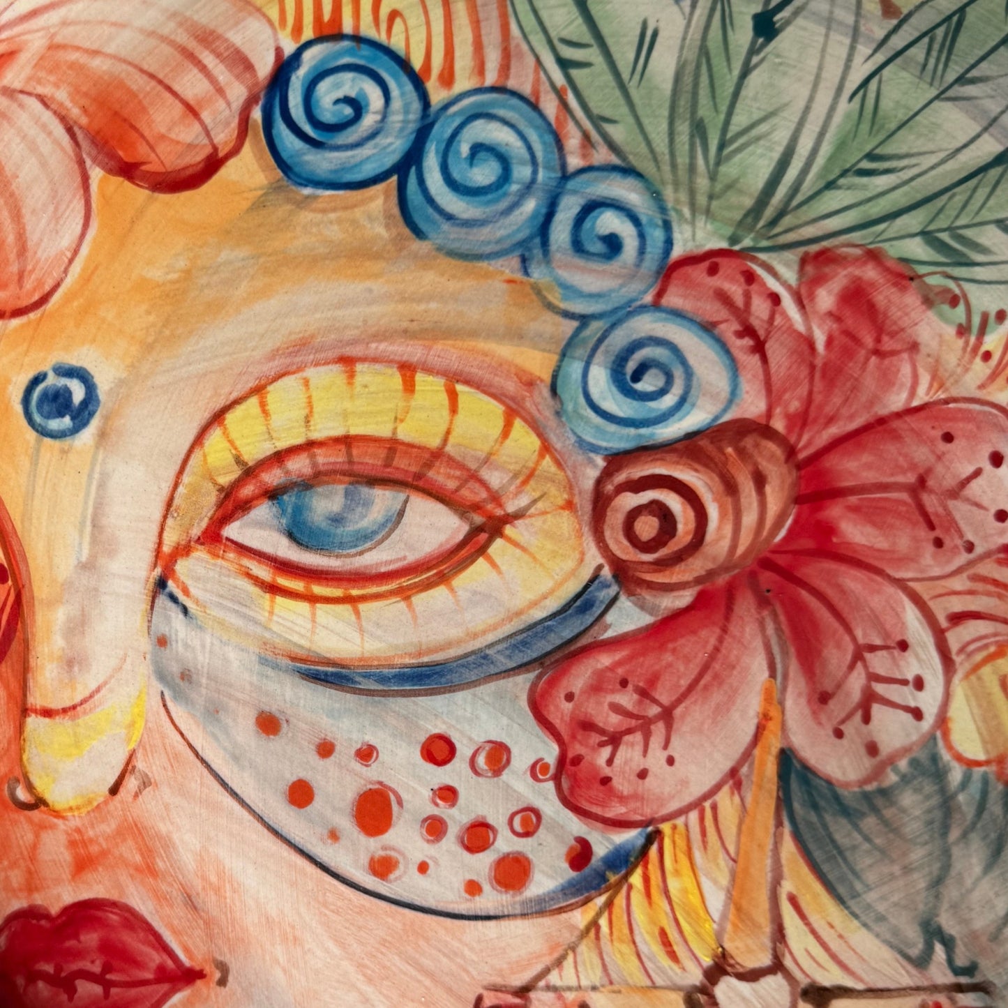 Colorful abstract floral and face-inspired artwork with a stylized eye, blue spiral motifs, red flowers, green leaves, and warm peach, yellow, orange, and blue tones - Malta