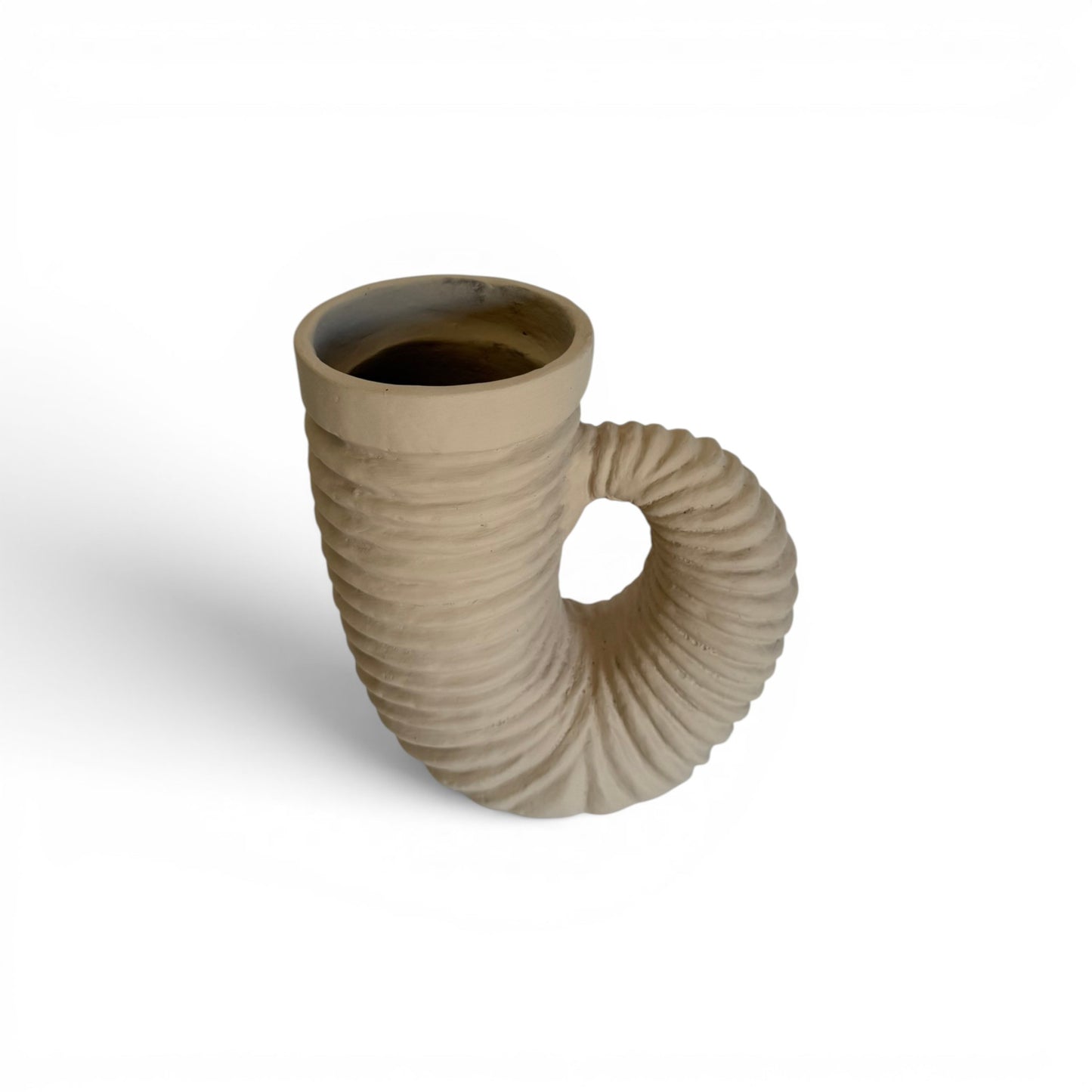 Sculptural sandy beige terracotta vase shaped like a ribbed curved horn with an integrated loop handle and wide rim opening.