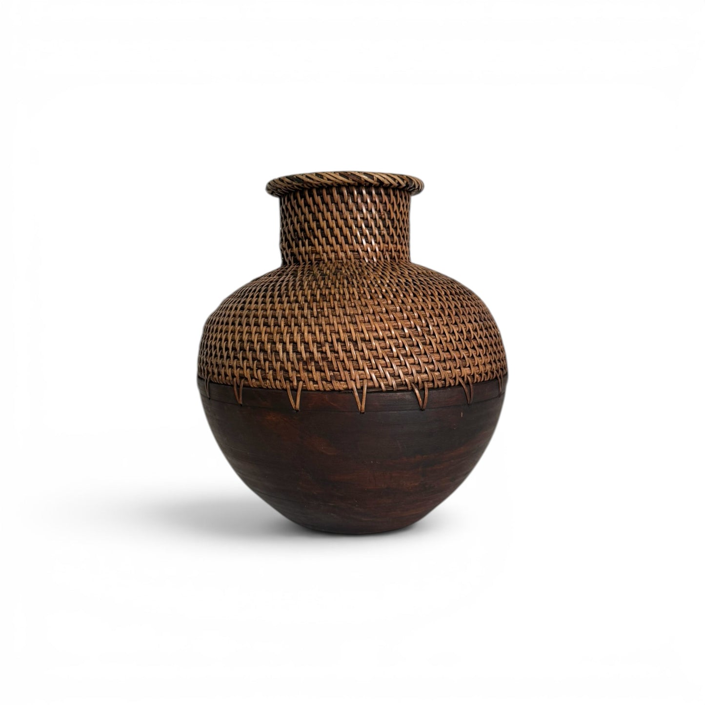 Bulbous tabletop vase featuring a dark-stained turned wood base seamlessly joined with a finely woven natural rattan neck and flared rim.